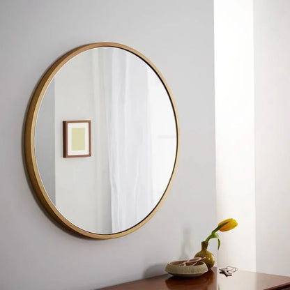 Round metal-framed wall mirror in black, white, or gold for bathroom.