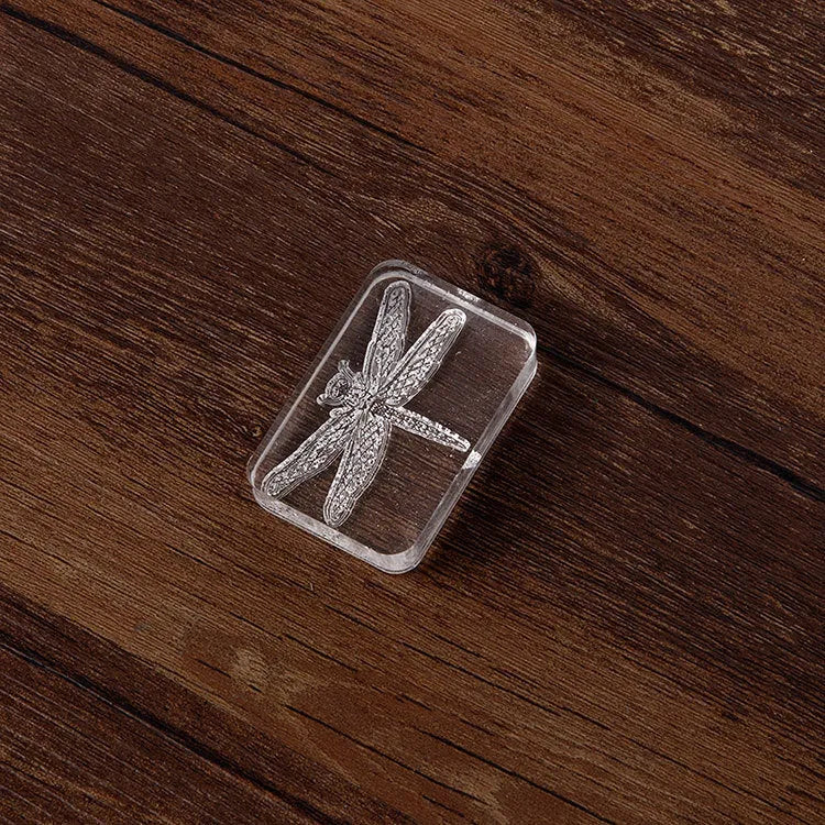 Transparent acrylic hand account seal with laser-engraved dragonfly design measuring 12mm height