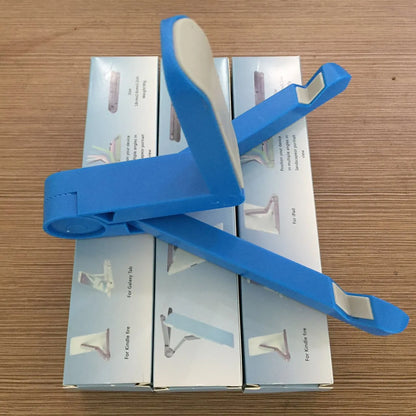 Black foldable tablet holder open in landscape mode holding a tablet, showing side buttons and non-slip base.