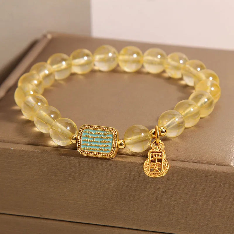 Women's natural yellow citrine crystal bracelet with rhinestone detailing.