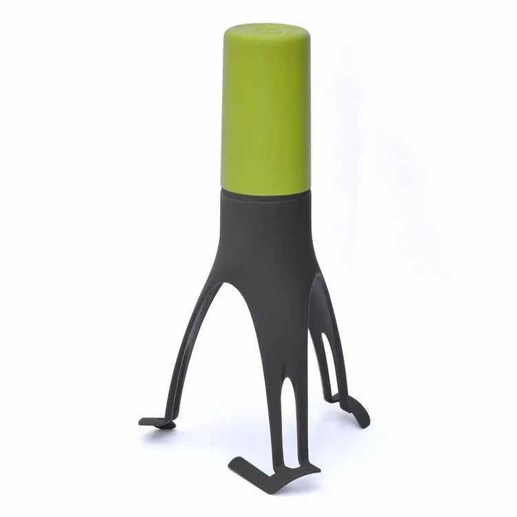 Uutensil Stirr automatic pot stirrer in grey placed inside a saucepan stirring sauce.