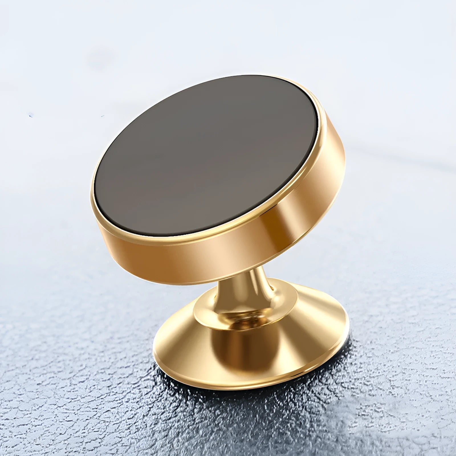 Silver aluminium alloy magnetic car phone holder with rotating ball head mounted on a car air vent.