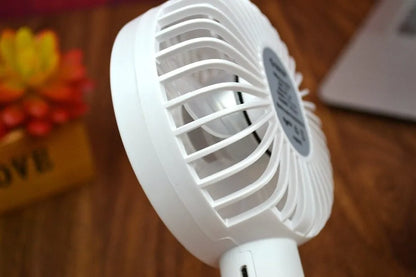 White ORICO FH1 portable USB rechargeable desk and handheld small fan with three speed buttons.