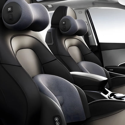 Black car massage cushion with headrest and lumbar support on a car seat, showing wired controller.