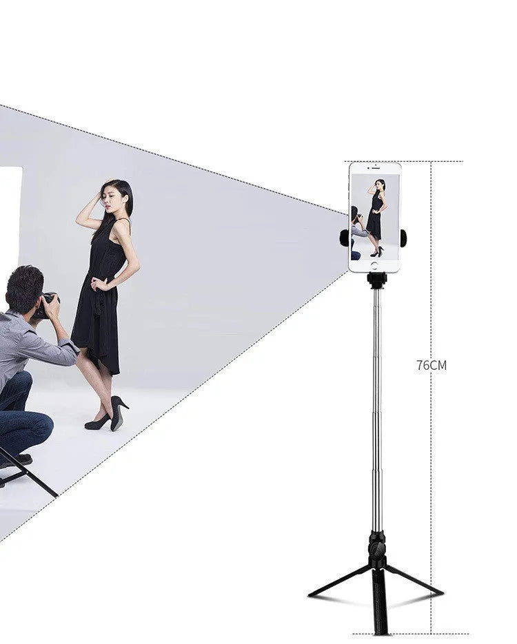 Black aluminium phone tripod stand with extended legs and a Bluetooth remote, holding an iPhone.