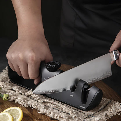 Grey-black manual sharpener with adjustable mechanism for knives and scissors measuring 265x70x45mm