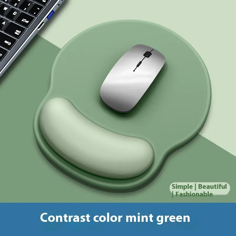 Silicone mouse mat with integrated wrist rest in a gradient blue black colour on a desk.