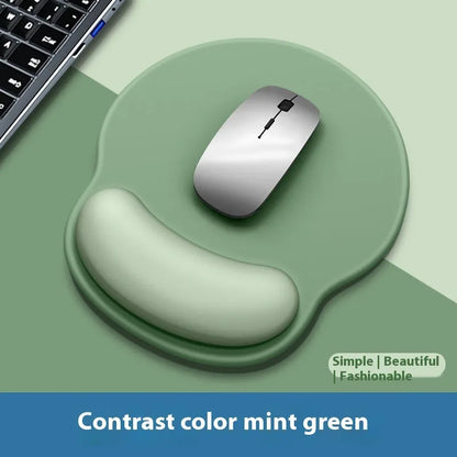 Silicone mouse mat with integrated wrist rest in a gradient blue black colour on a desk.
