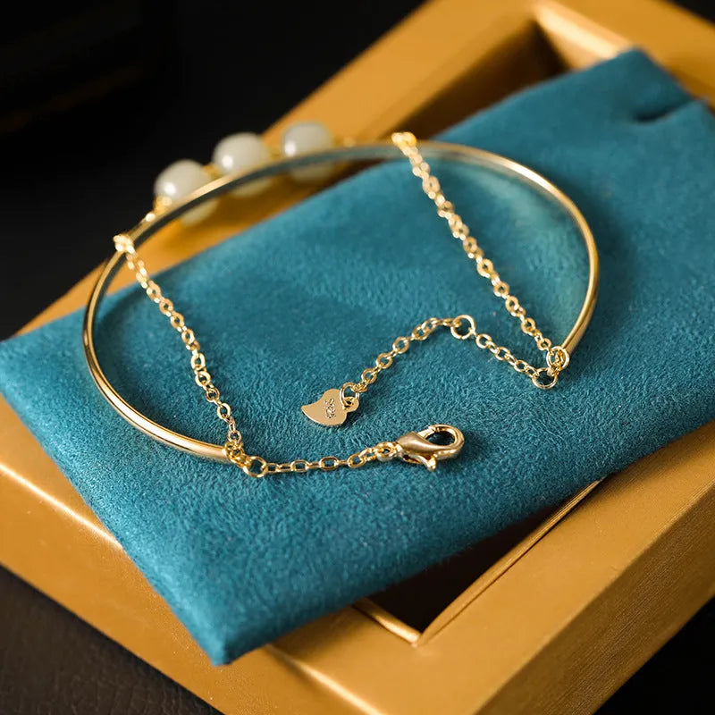 Women's Hetian jade lucky beads bracelet with gold inlay, shown in faux two-piece design.