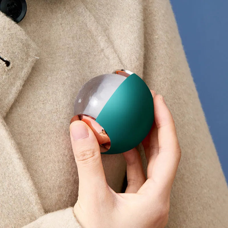 Reusable gel lint roller ball in green gold colour for removing pet hair and lint from fabrics.