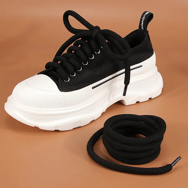 Round woven white, beige, and black shoelaces for bread shoes showing different lengths on a flat surface.