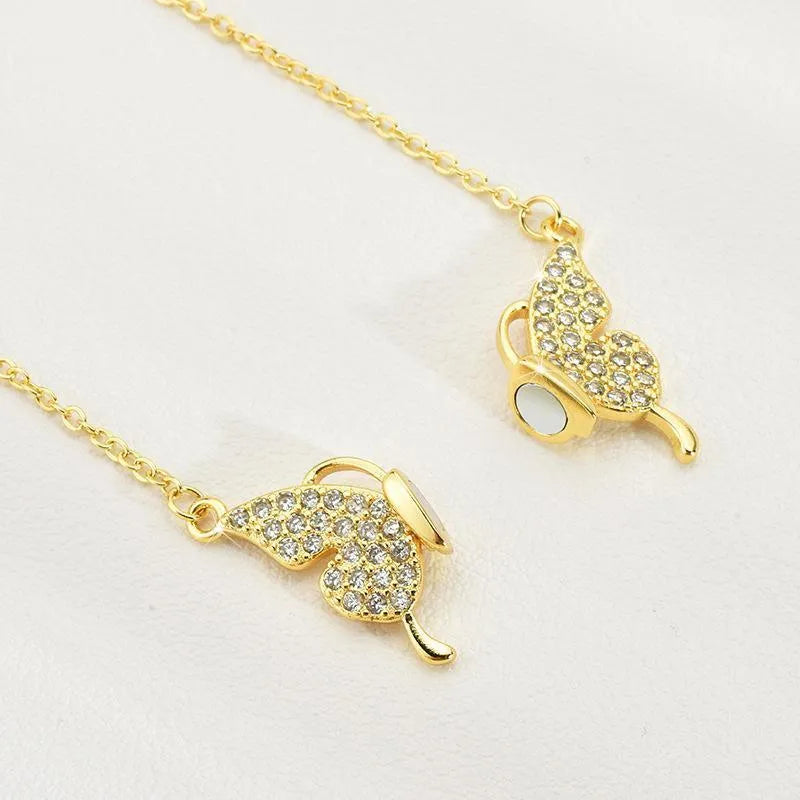 Close-up of a gold titanium steel twisted chain necklace with a magnetic butterfly clasp.