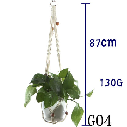 Handmade beige cotton rope net bag holding a plant pot, showing its textured sling design.