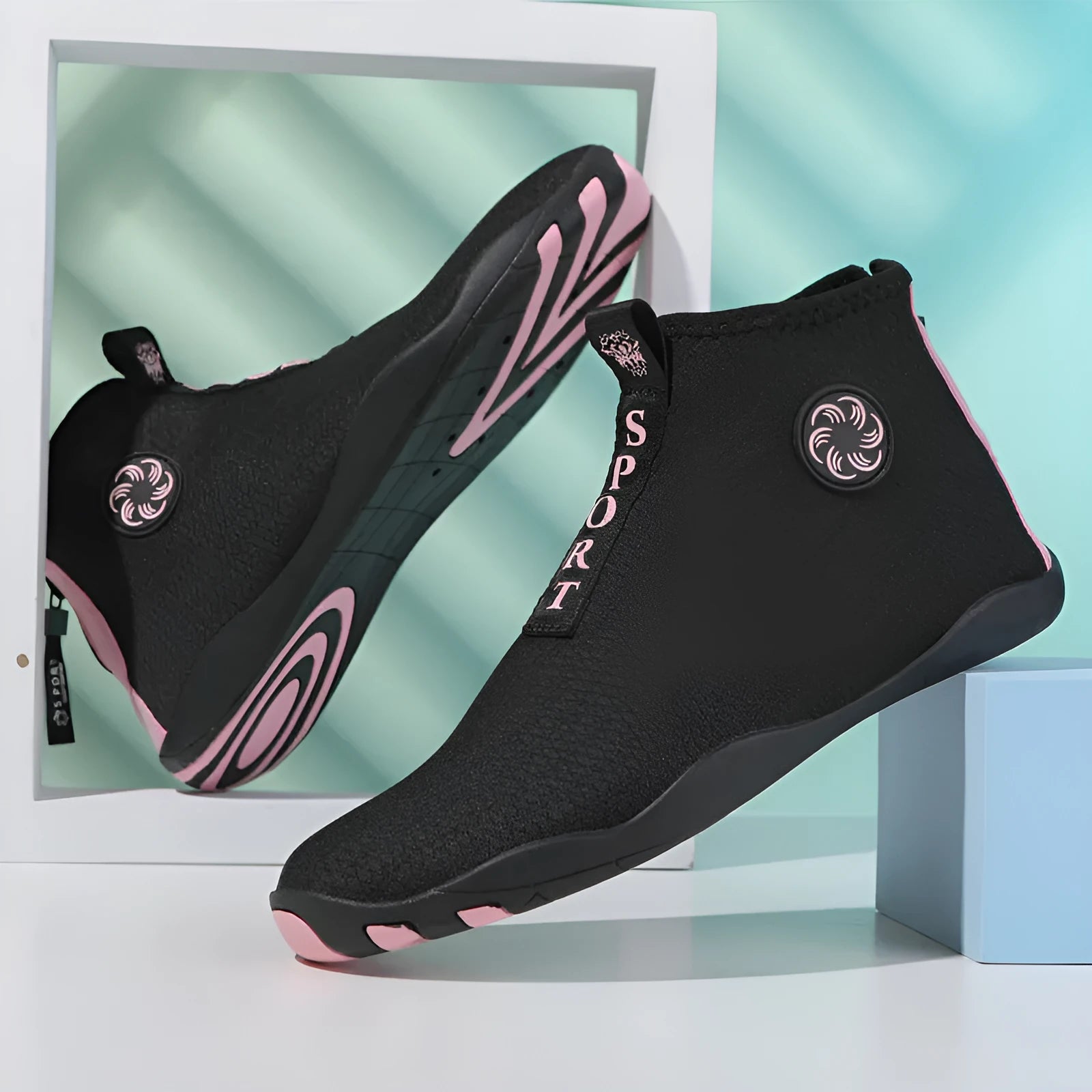 Mid-top outdoor beach shoes in black and fluorescent green with mesh upper and rubber sole.