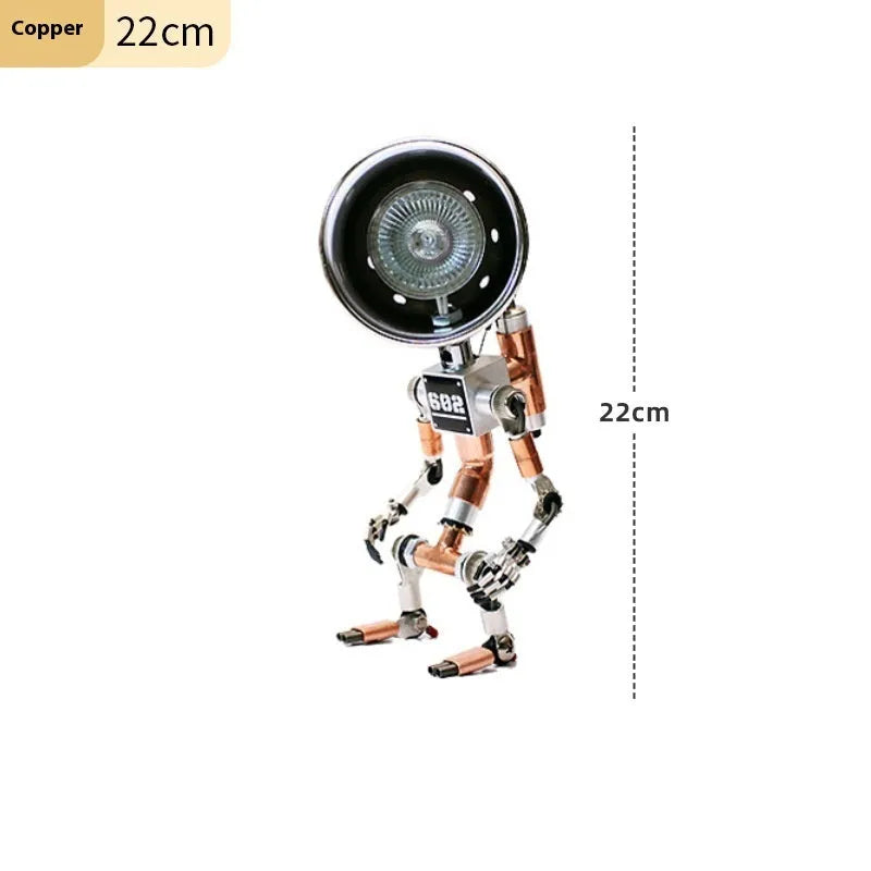Silver copper robot-shaped decorative desk lamp with custom graphic option on a wooden shelf.