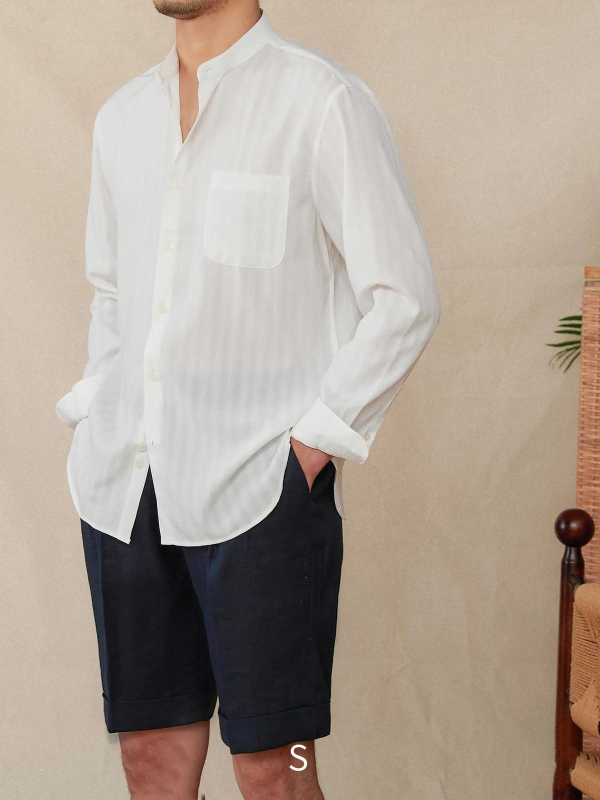 Blue and white seersucker striped long sleeve shirt with a loose lapel baseball collar.