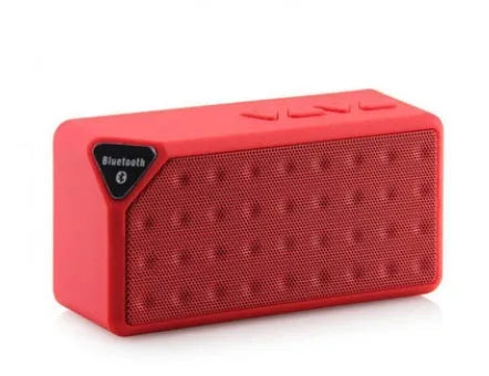 Cannon X3 small cube-shaped wireless Bluetooth speaker in multiple colours on a table.