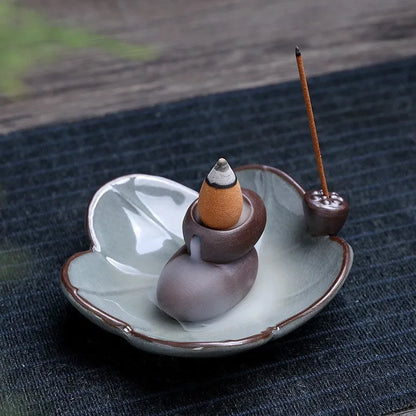 Square ceramic incense burner with reverse flow design showing smoke cascading down sides, Ge kiln crackle glaze patterns visible