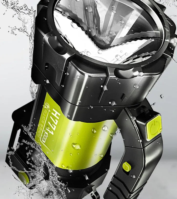 H771 portable LED searchlight in orange or green with shoulder strap and removable battery.