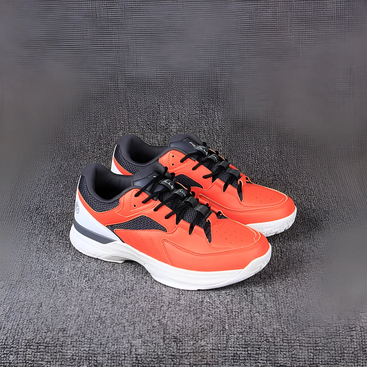 Orange men's wide fit tennis shoes with suede and mesh upper, lace-up closure, and rubber outsole.