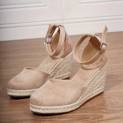 Women's Roman-style wedge sandals in suede with buckle fastening, shown in apricot and black colours