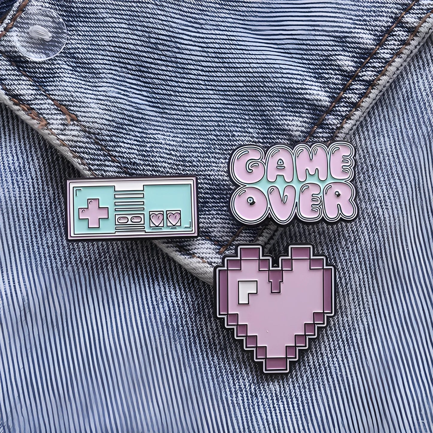 Stereo game console badge made of alloy metal for bag or jacket attachment.
