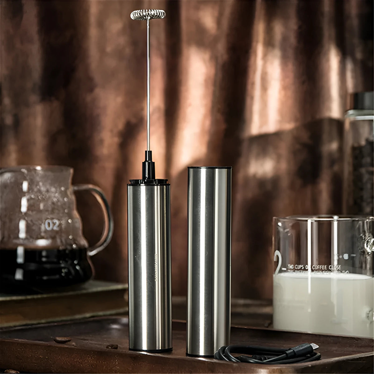 Silver handheld electric milk frother with detachable stainless steel whisk head