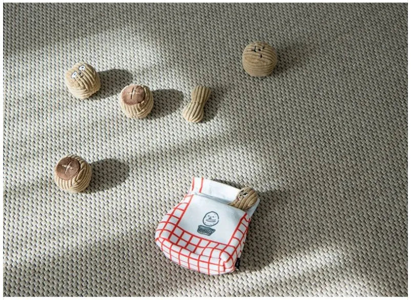 Dog sniffing toy set with two walnut pieces, one peanut piece and snack bag with rustling paper