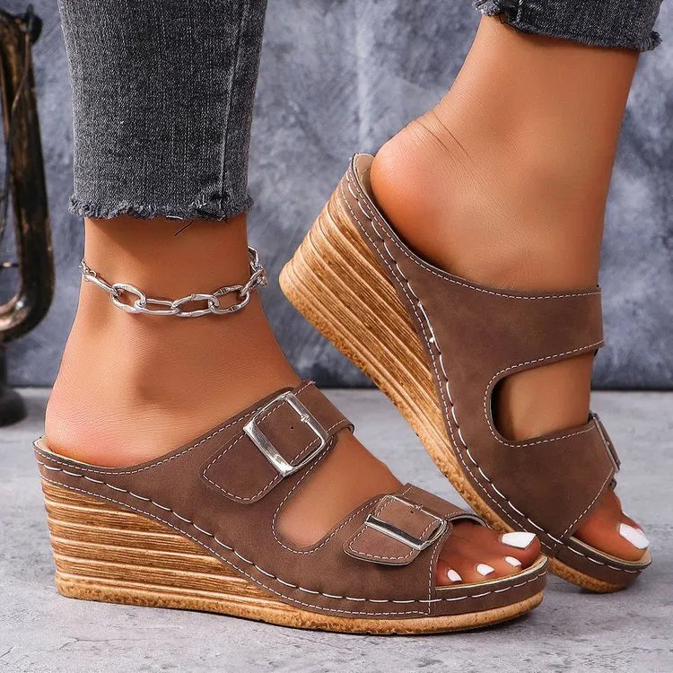 Women's creamy-white outer wedge beach slippers with a belt buckle detail on the strap.