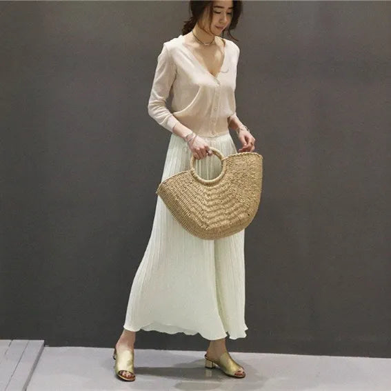 Woven paper rope and straw crescent handbag in natural light brown with hard handle and drawstring closure