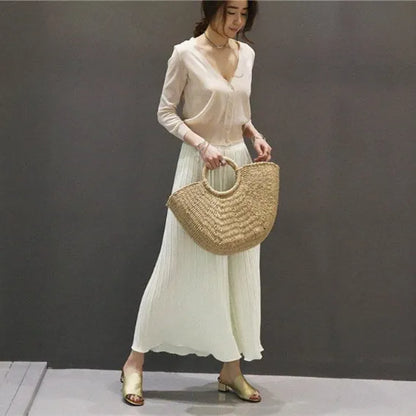 Woven paper rope and straw crescent handbag in natural light brown with hard handle and drawstring closure