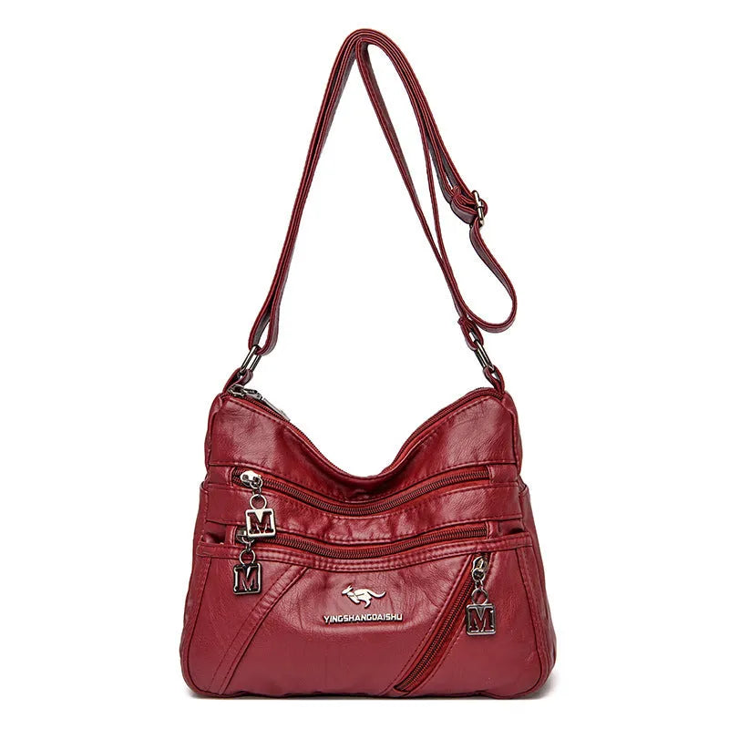Middle-aged women's double layer PU shoulder bag with large capacity, welt pocket, and soft build in red, purple, dark blue, black, bronze, gray, or tan.