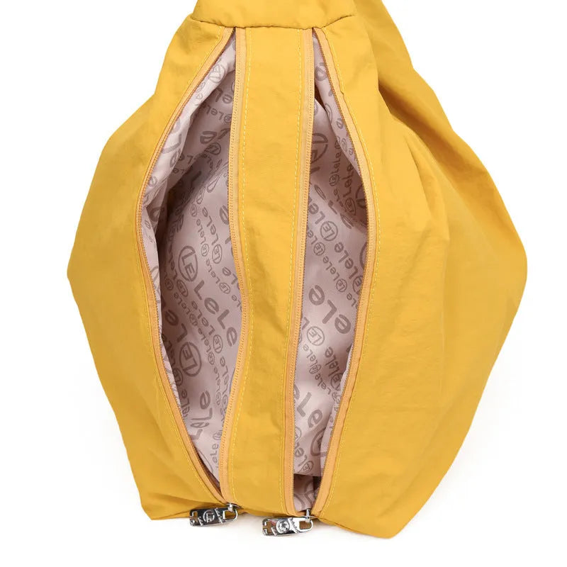 A soft nylon underarm bag with a heart-shaped design in blue, shown worn crossbody.