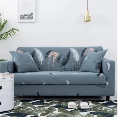 Printed stretchable sofa slipcover with geometric abstraction pattern on a three-seater sofa, showing tight fit and modern design.