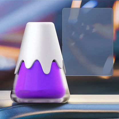 Snow Mountain Cup car air freshener, a purple glass vessel with ceramic paste, placed on a car dashboard