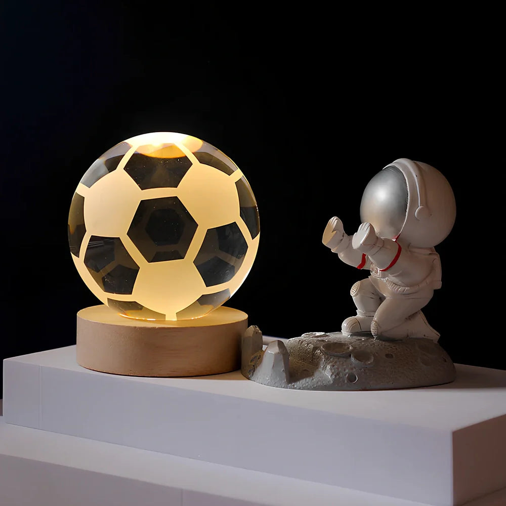Cosmos Series crystal ball night light with wooden base and astronaut figure, showing Milky Way light pattern