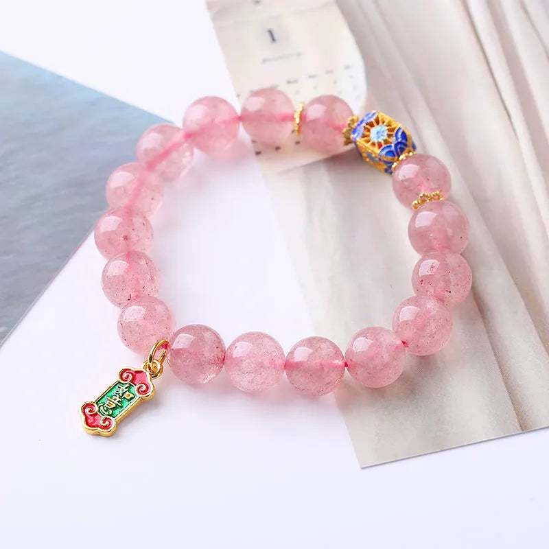 Pink crystal bracelet with Strawberry Quartz stones and Ruyi charm in hand-woven women's jewellery design