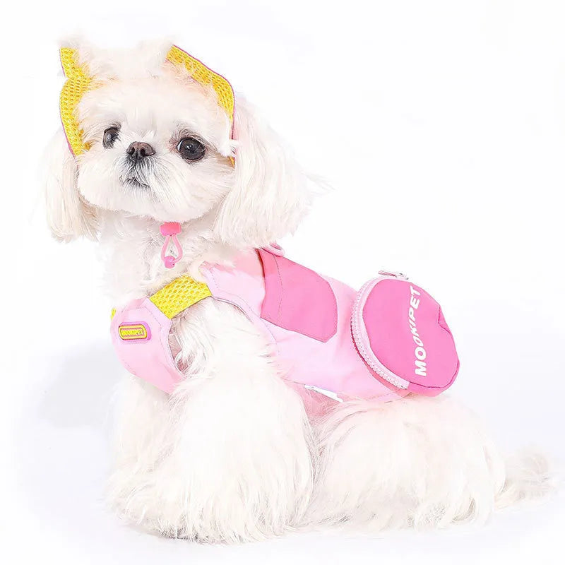 Pink polyester dog vest harness on a small white dog, showing back traction loop and casual fit.