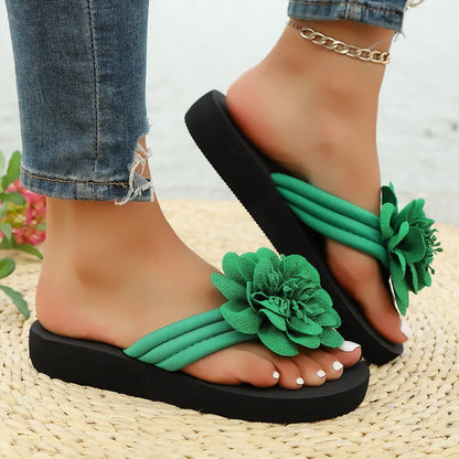 Solid-colour flower flip flops with a decorative floral detail on a viscose upper and EVA sole.