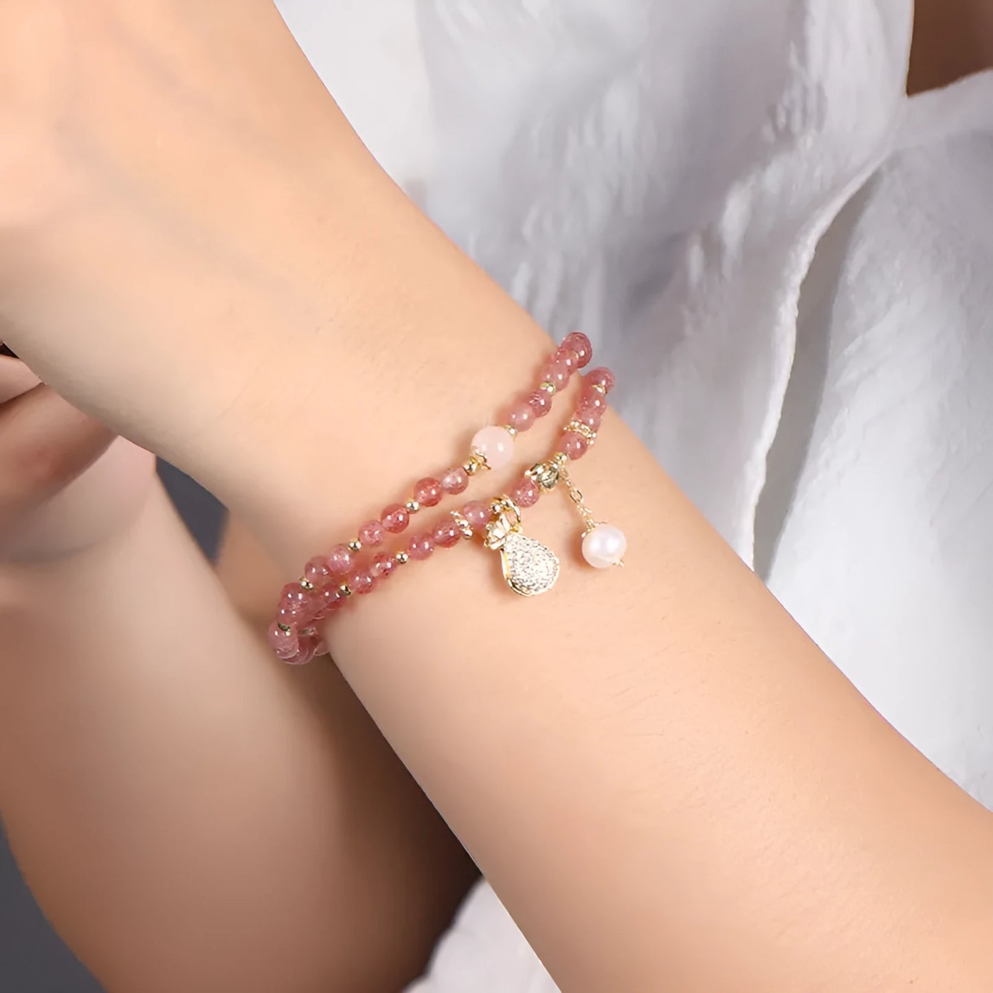 Geometric strawberry quartz crystal bracelet for women on a white background.