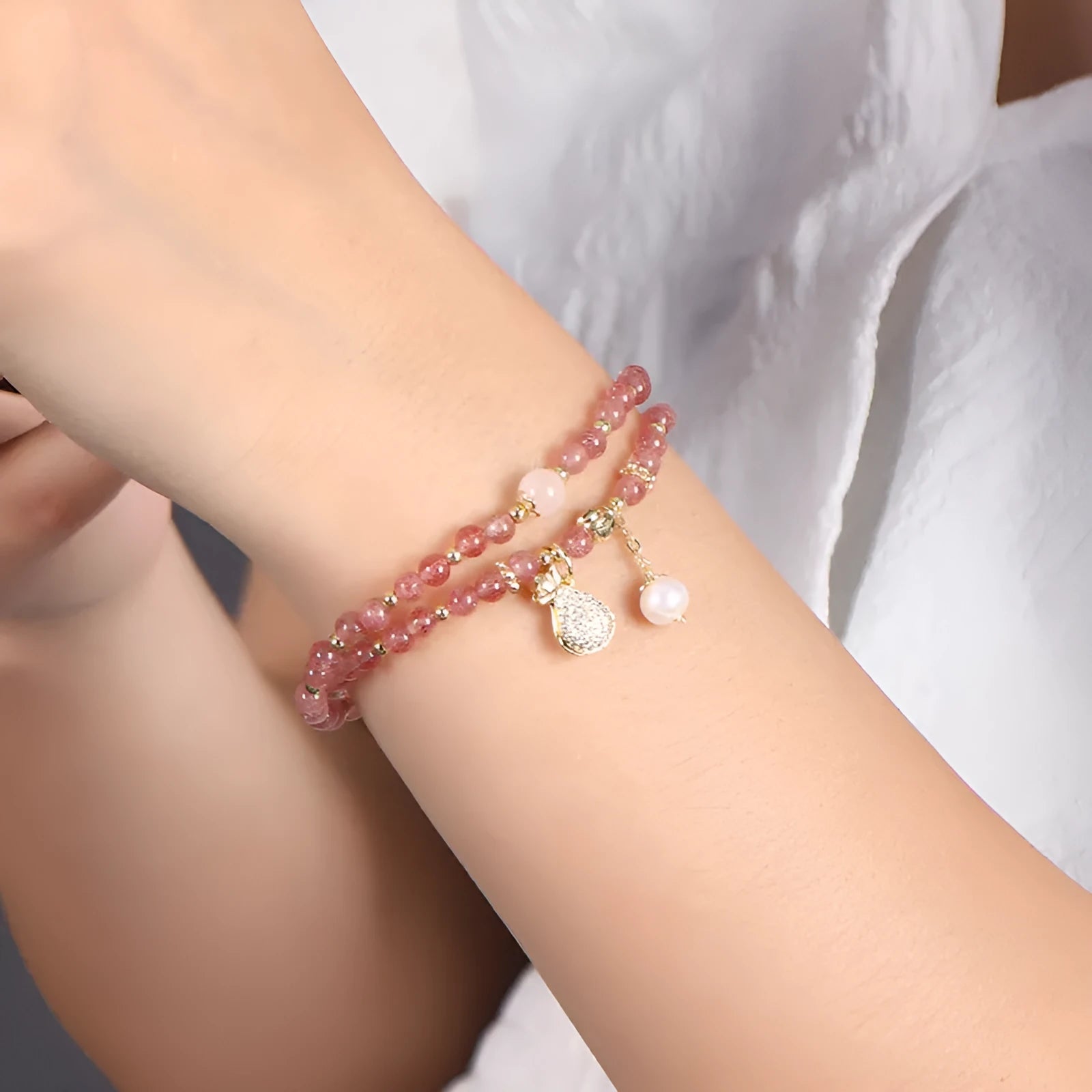 Geometric strawberry quartz crystal bracelet for women on a white background.