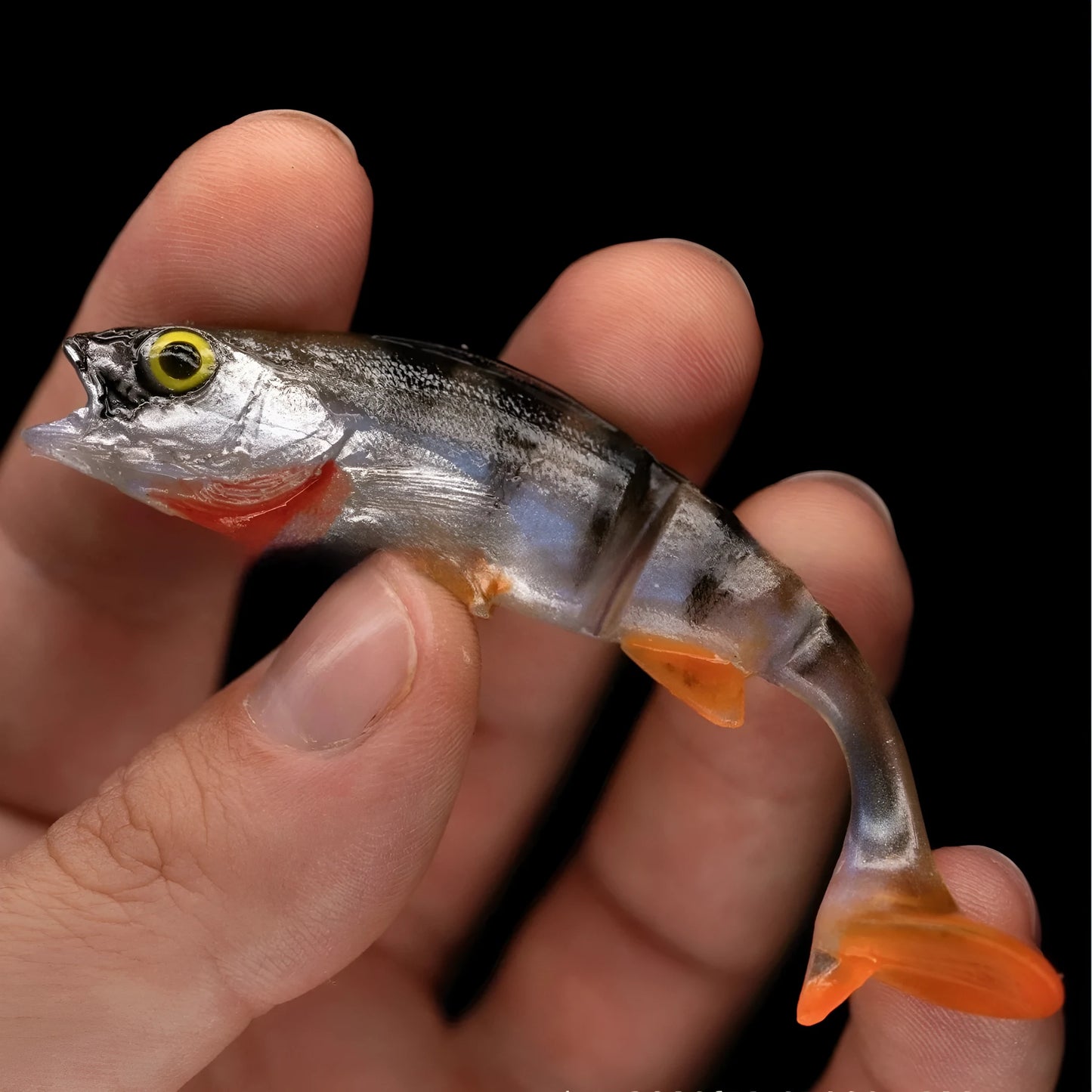 Two fish-shaped soft plastic fishing lures for catfish and sea fishing on a blue background.