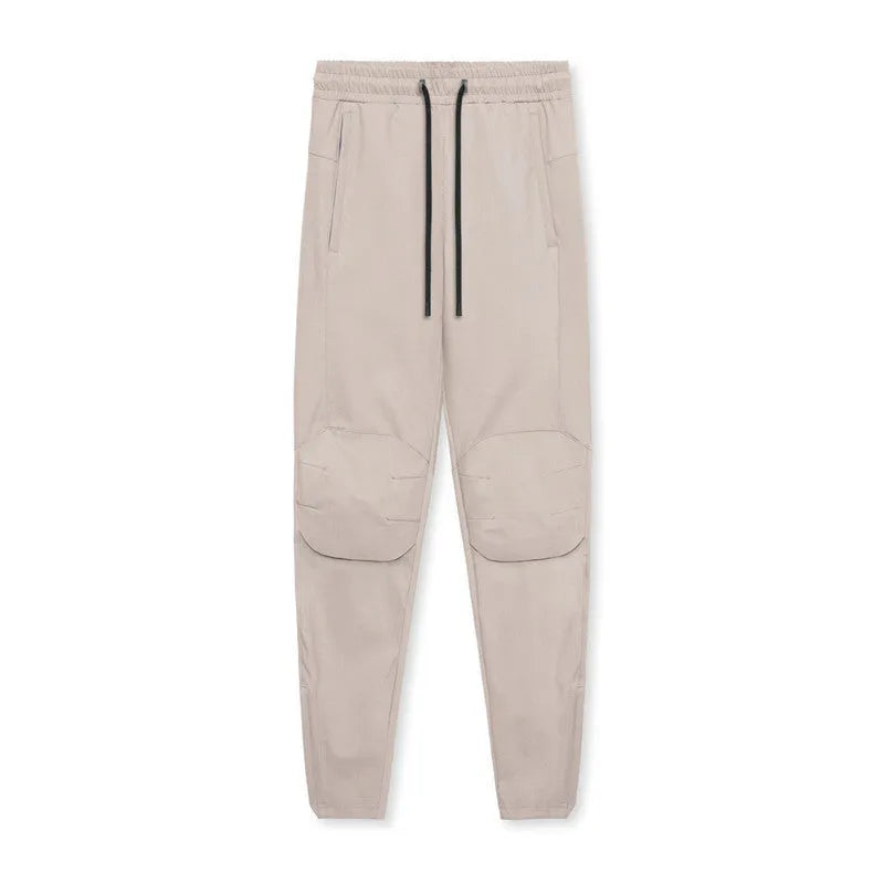 Men's grey fitness trousers with ankle ties, made from 100% polyester for quick-drying during exercise