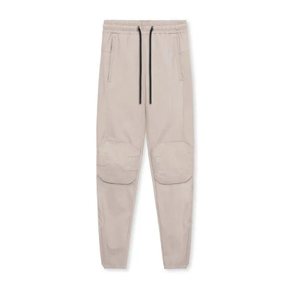 Men's grey fitness trousers with ankle ties, made from 100% polyester for quick-drying during exercise