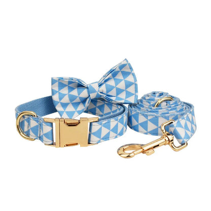 Blue cloth dog accessory set with collar, leash, bow, and vest shown together