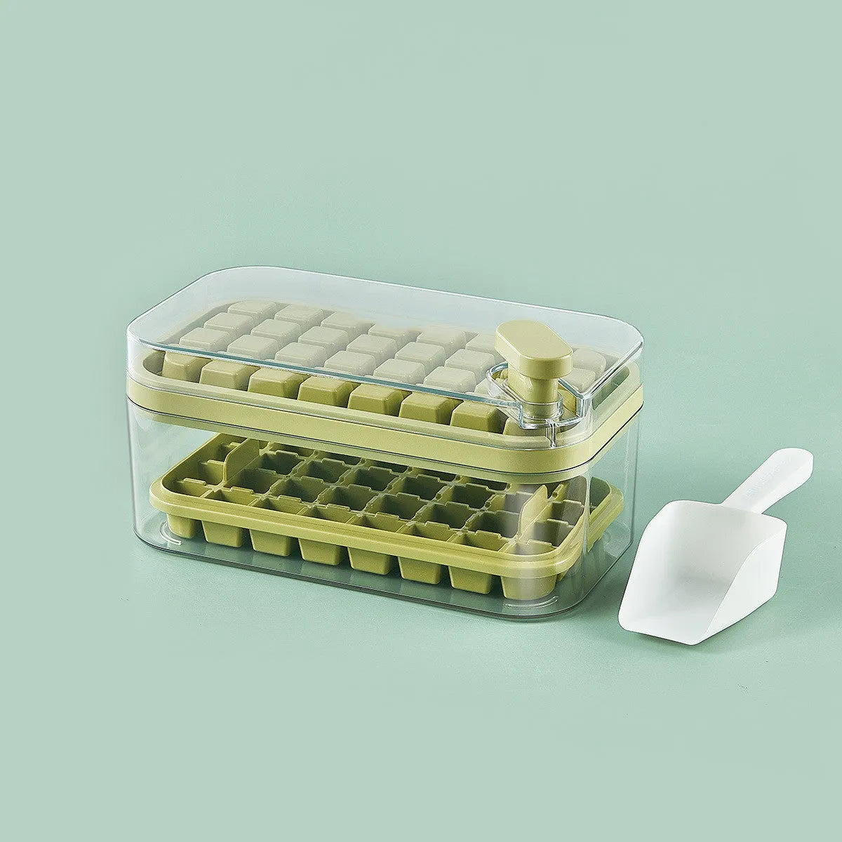 Green one-button press ice mould box with storage lid and ice shovel on kitchen counter
