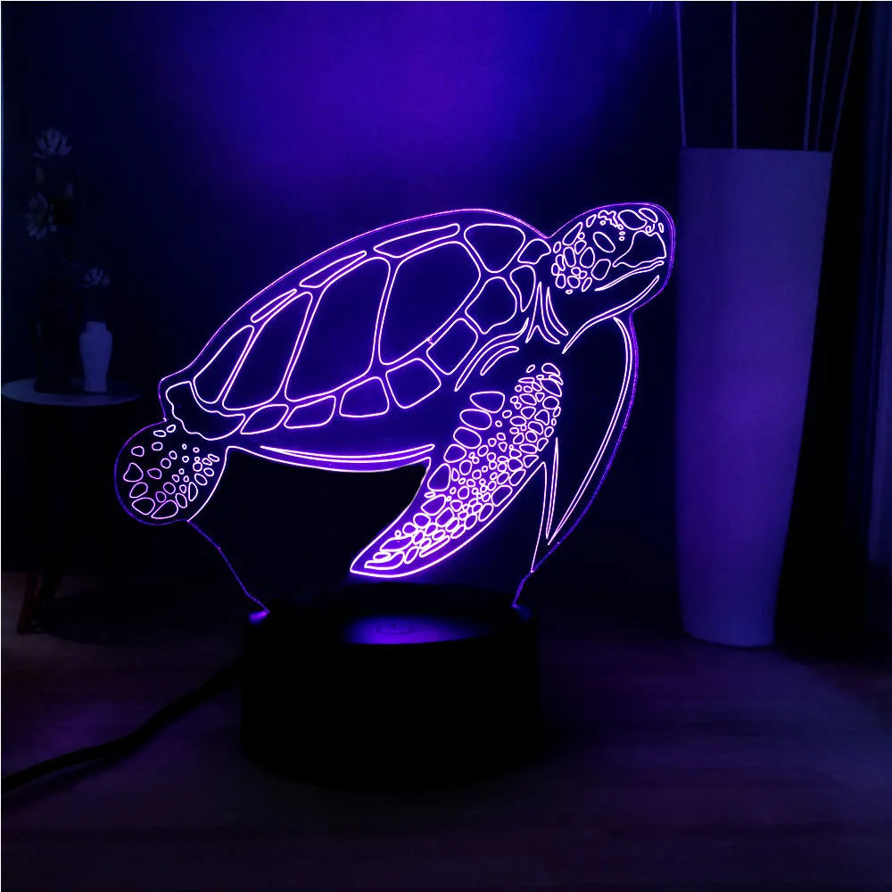 3D acrylic turtle-shaped LED night light showing one of its 16 colour options on a bedroom shelf.