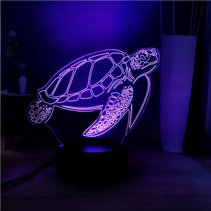 3D acrylic turtle-shaped LED night light showing one of its 16 colour options on a bedroom shelf.