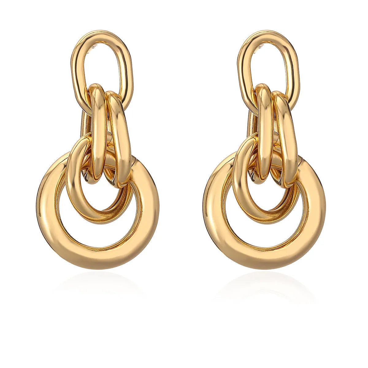 A pair of gold-coloured geometric drop earrings with irregular shapes, made from copper.