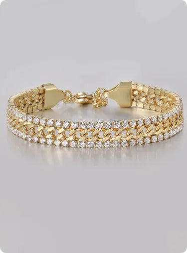 Gold-coloured titanium steel tennis bracelet with artificial gemstone inlay on a wrist.